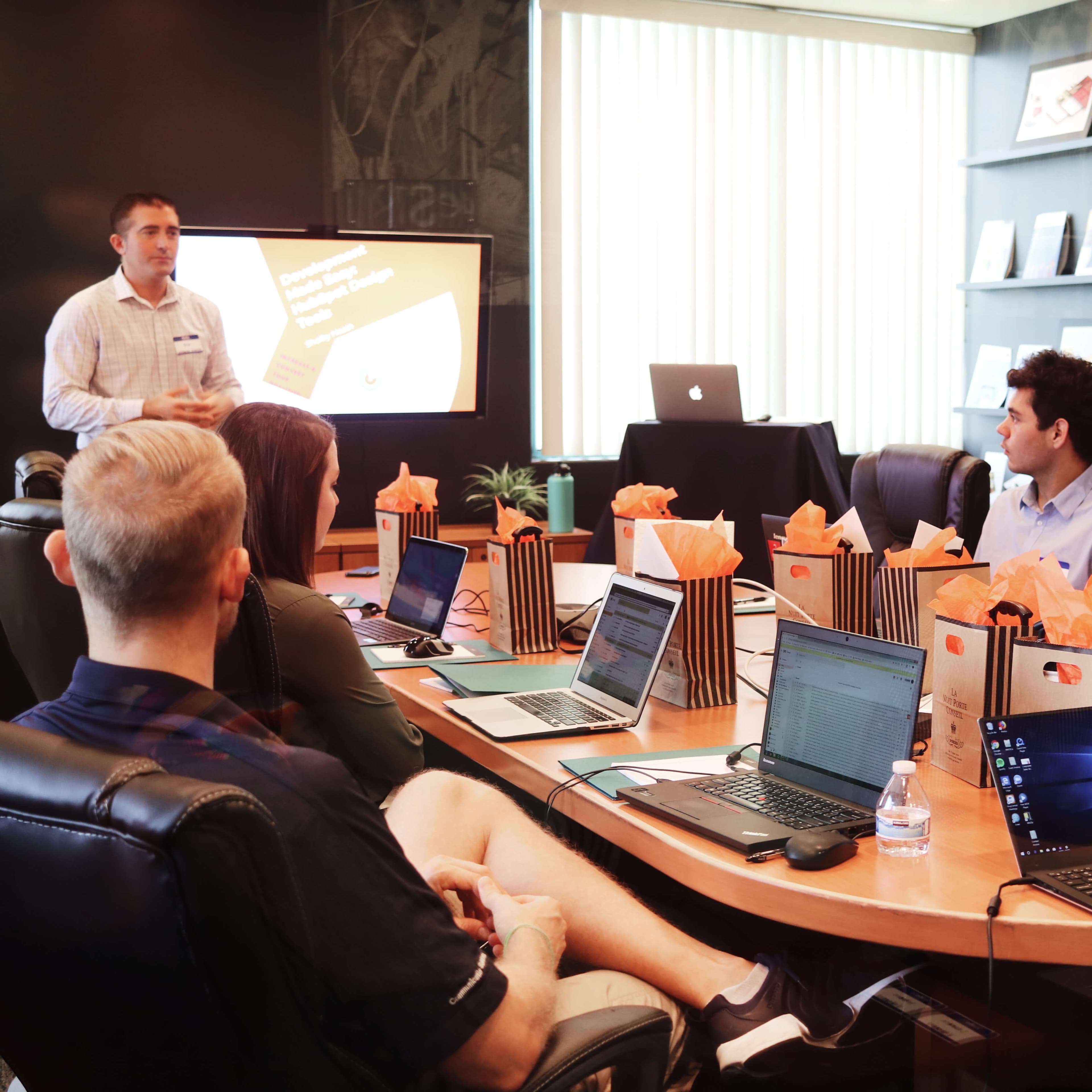 Employees in a conference room discussing the company's development.